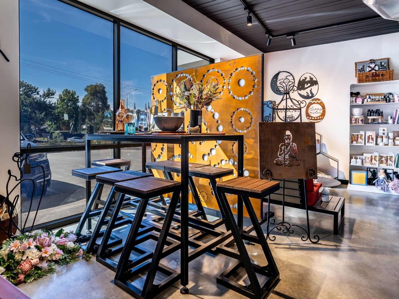 LaTink showroom featuring outdoor bar table set and Corten steel garden screen