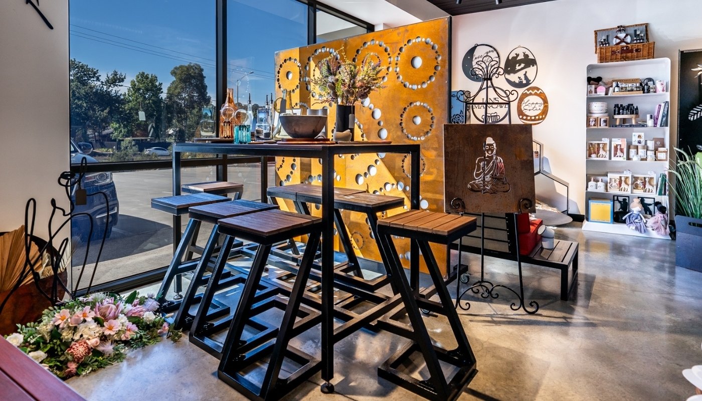 LaTink showroom featuring outdoor bar table set and Corten steel garden screen