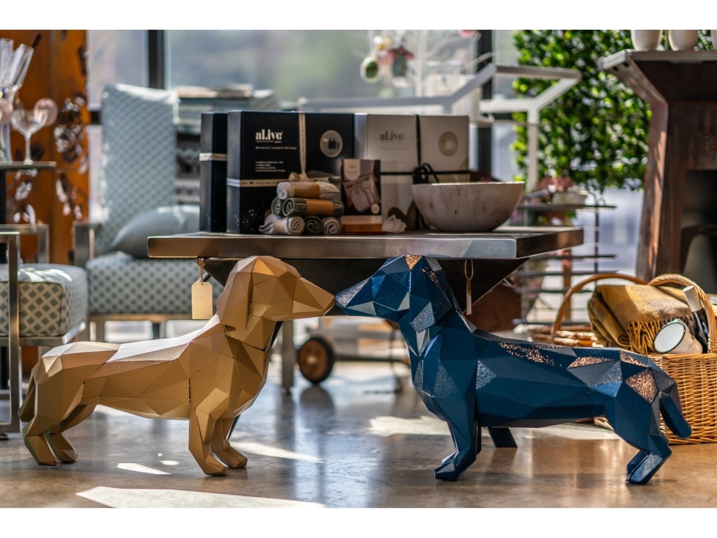 LaTink showroom featuring two geometric dog sculptures, one brown and one blue.